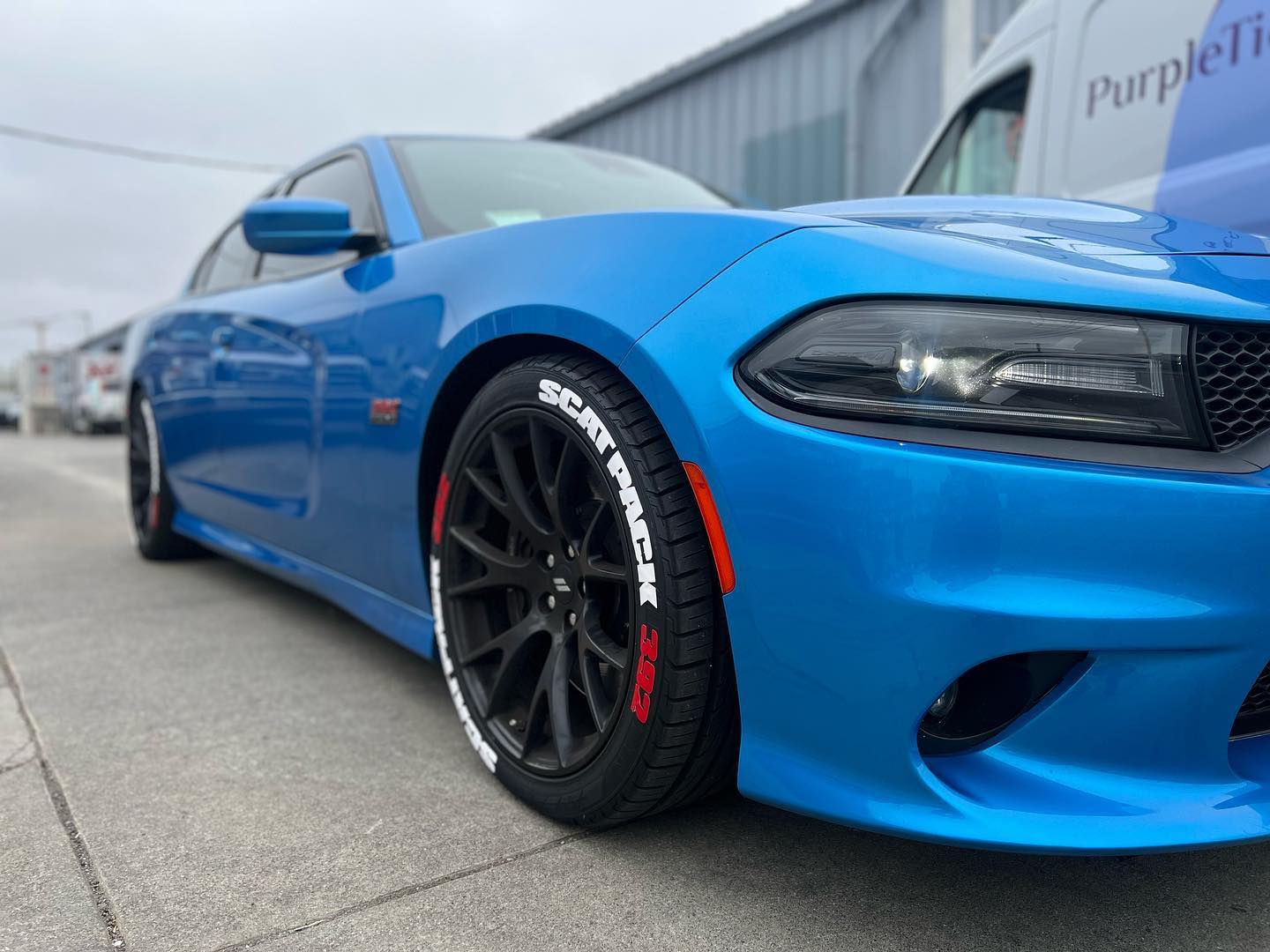 Blue car with custom wheels outside Castellon Tires