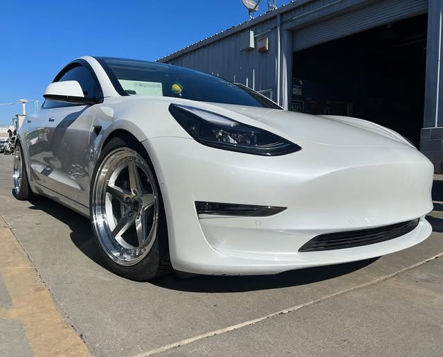 White Tesla with custom wheels outside Castellon Tires